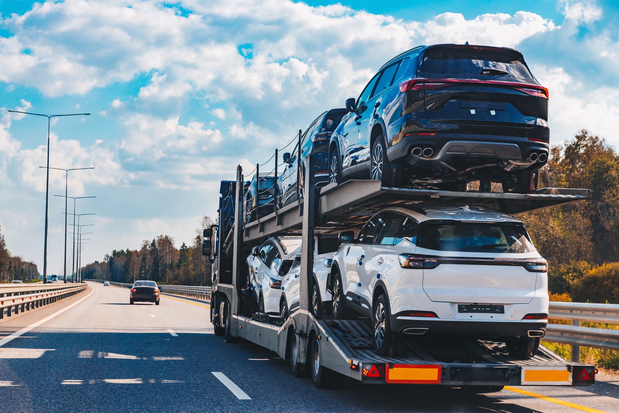 Car transport truck driving on highway road. Car Carrier Trailer on asphalt road